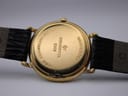 Close-up of the watch case back, revealing engravings including "10M GOLD ELECTROPLATED", "RAYMOND WEIL", "9140", and "WATER RESISTANT".