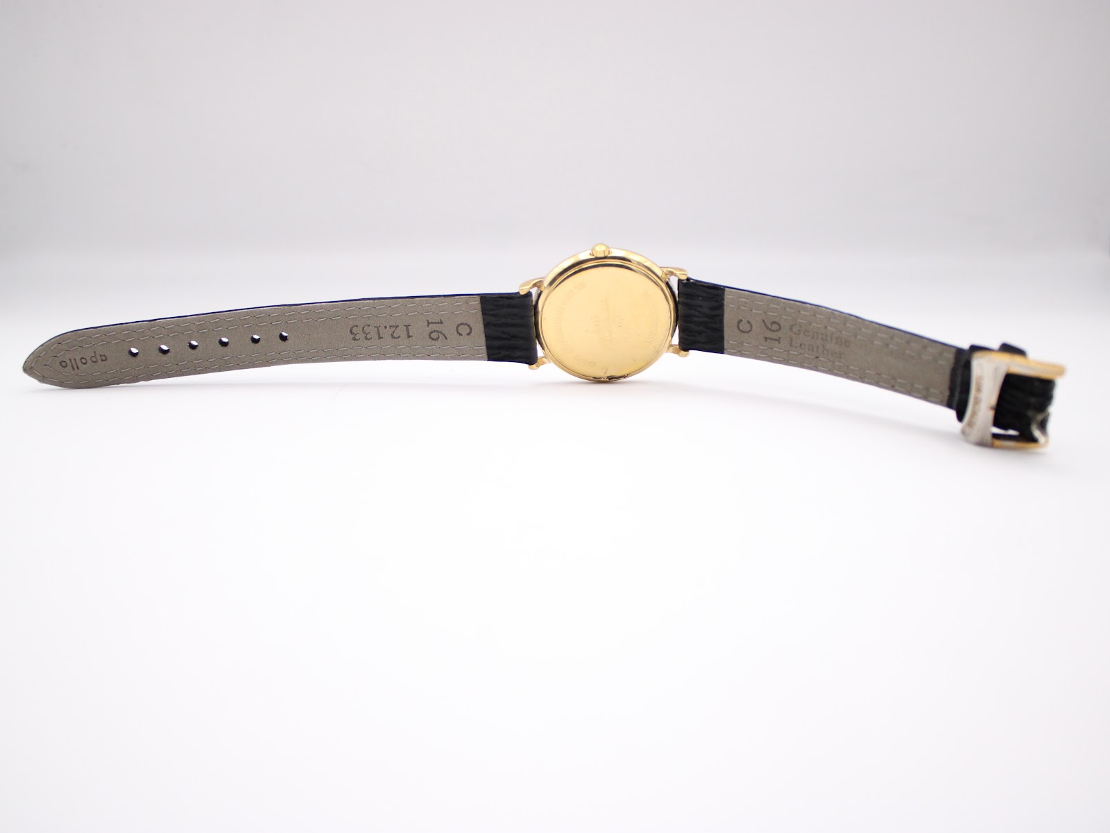 View of the back of the watch and strap, showing "16" lug width marking and "Genuine Leather" embossed on the strap.