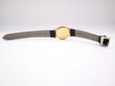 View of the back of the watch and strap, showing "16" lug width marking and "Genuine Leather" embossed on the strap.