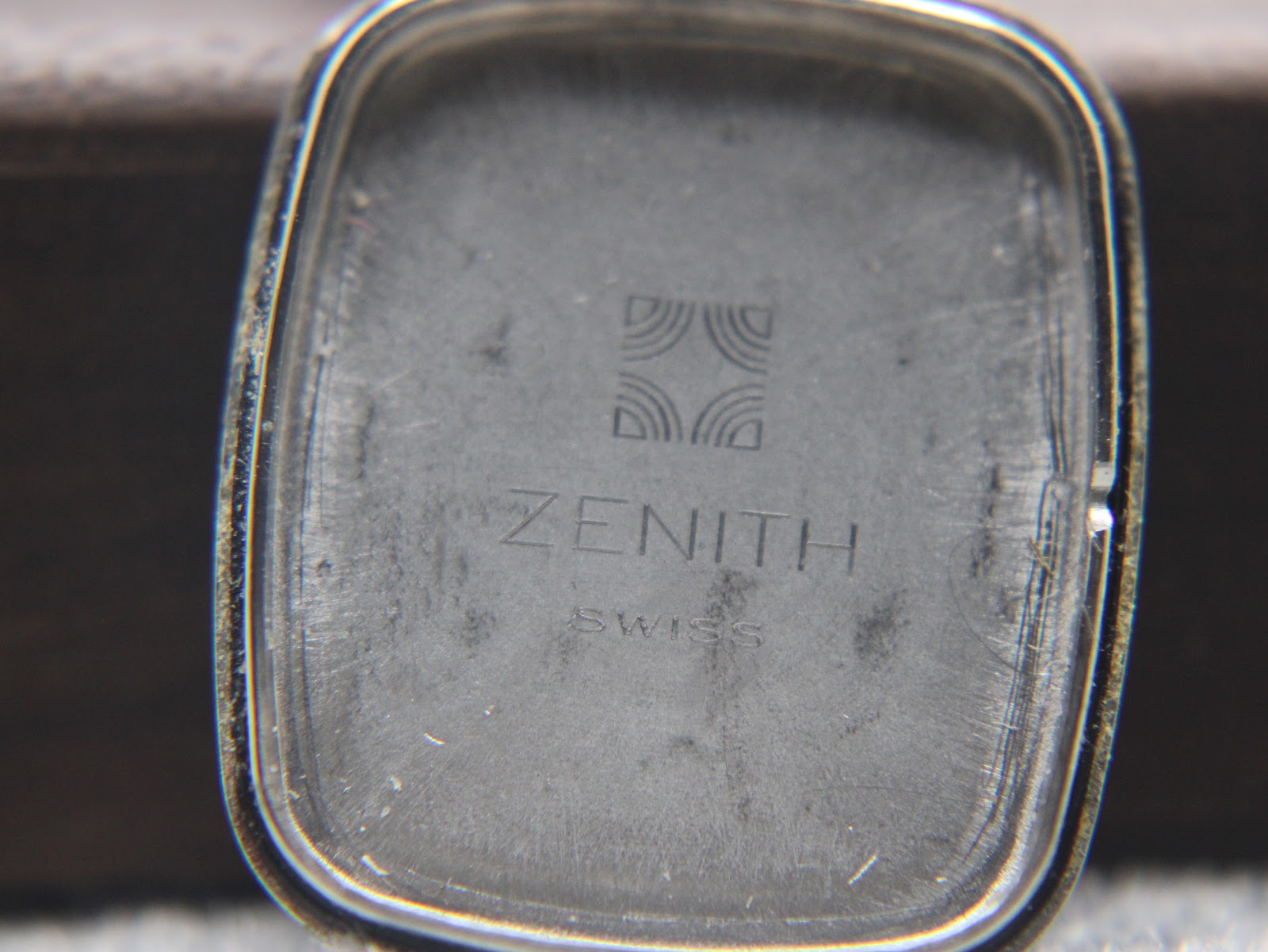 Close-up of the inner case back of the Zenith watch, showing Zenith logo and 'Swiss' text.