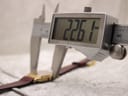 Digital caliper measuring the case width of the Zenith watch, displaying 22.61mm.