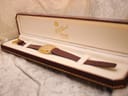 Zenith watch with burgundy strap placed inside a brown display box by F.H. Buck Jewellers.