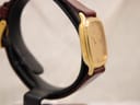 Angled side view of the Zenith watch on a black watch stand, highlighting the case shape.