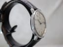 Another angled side view of the Omega De Ville watch, showing the case profile with some wear and reflections on the polished bezel.