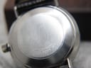 Close-up of the solid stainless steel case back of the Omega De Ville, with "WATERPROOF" and reference number "166033-TOOL 106" engraved.