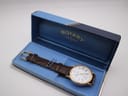 The Rotary watch nestled inside an open vintage blue and gold Rotary presentation box, showing the inner blue lining.