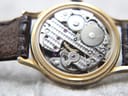 Close-up view of the intricate mechanical hand-wind movement inside the Rotary watch case.