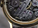 Extreme close-up of the watch movement, showing "seventeen jewels unadjusted" engraving on a bridge.