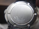 Close-up of the brushed stainless steel case back of the Omega Genève Dynamic, showing the tool markings and "WATERPROOF" text.