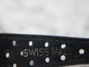 Close-up of the blue perforated leather strap, showing the embossed "SWISS MADE" text and strap holes.