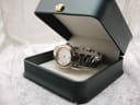 The Gucci 8900L bi-tone watch displayed in a dark green presentation box, highlighting its elegant appearance.