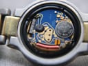 Detailed internal view of the Swiss quartz movement, showing the 7 jewels, "Gucci" marking, and a Renate battery.
