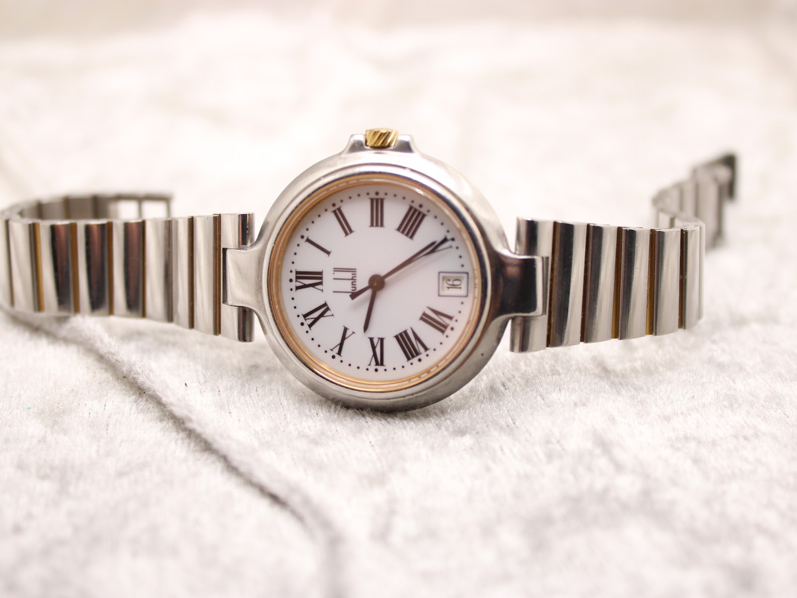 Full front view of the Dunhill Millennium watch with its two-tone bracelet laid flat.