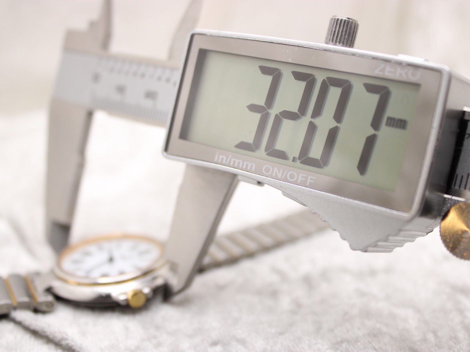Digital caliper measuring the case diameter of the Dunhill Millennium watch, showing 32.07mm.