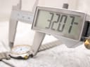 Digital caliper measuring the case diameter of the Dunhill Millennium watch, showing 32.07mm.
