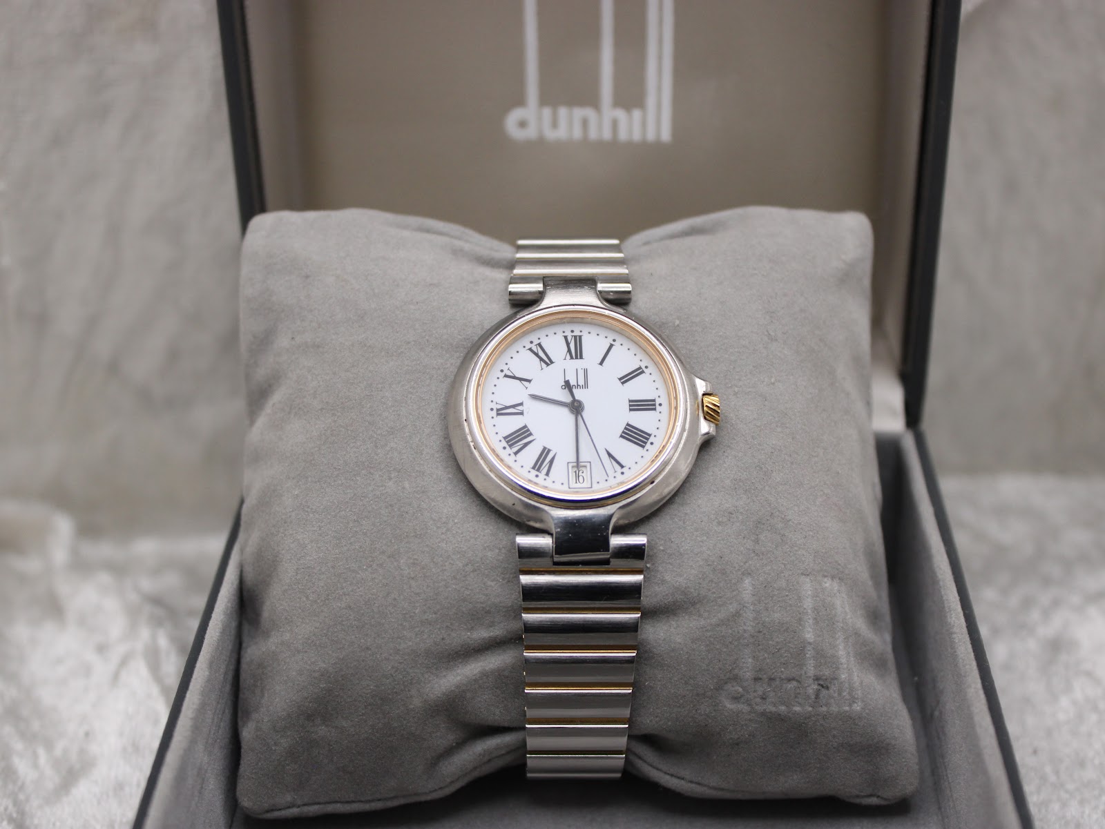 Dunhill Millennium watch displayed on its cushion inside the original Dunhill presentation box.