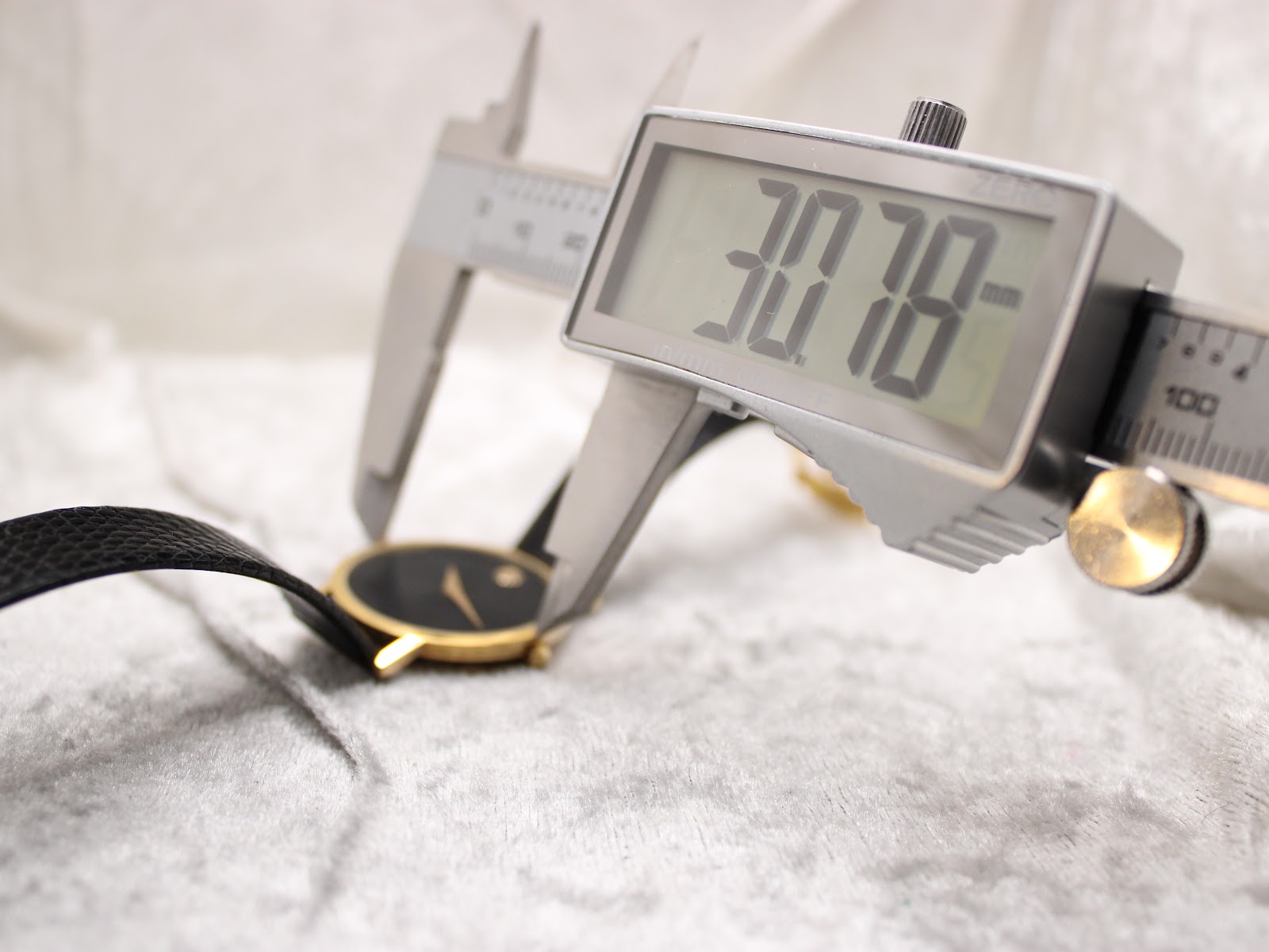Digital caliper measuring the case diameter of the Movado Museum watch, displaying 30.78mm.