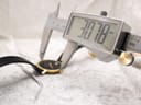 Digital caliper measuring the case diameter of the Movado Museum watch, displaying 30.78mm.