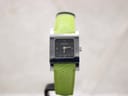 Front view of the Gucci 7900P watch, showing the black rectangular dial with Roman numerals and the bright green textured leather strap on a watch stand.