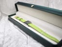 The Gucci 7900P watch nestled inside a deep green rectangular presentation box with a cream-coloured lining, ready for gifting.
