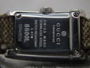 Close-up view of the Gucci 8600L stainless steel case back, showing engravings for "Swiss Made", "Water Resistant 3 ATM", "8600L", and serial number.