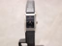Front view of the Gucci 8600L ladies watch with a black dial and Roman numerals, presented on a white background.
