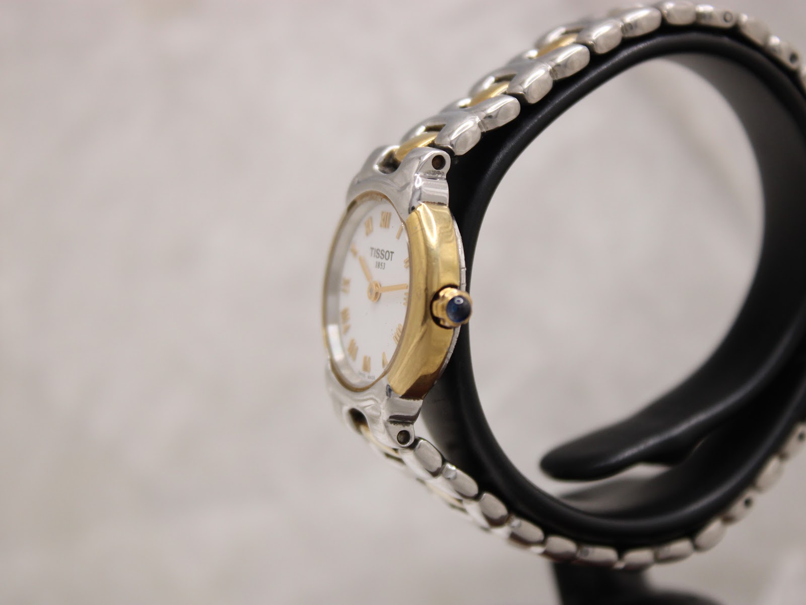 Side profile of Tissot G327 22mm round case showing slim dress watch silhouette and gold-plated finish