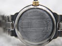 Close-up of Tissot G327 white dial with gold baton indices and blue cabochon crown detail
