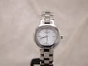 Front view of Tissot SKQ-JA G330K ladies watch with white mother of pearl dial and stainless steel bracelet.
