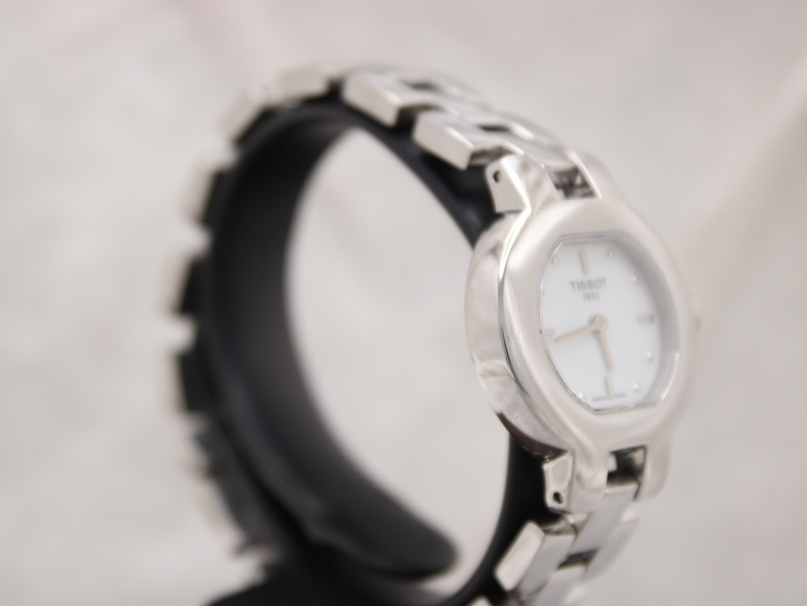 Another side angle of the Tissot watch, highlighting the integrated bracelet design.