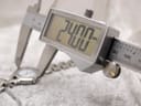 Digital caliper measuring the watch case diameter at precisely 24.00mm.