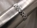 Stainless steel bracelet being measured on a wrist sizing gauge, showing a circumference of 160mm.