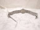 Rear view of the Tissot watch and bracelet laid flat, showing the case back and fully extended bracelet.