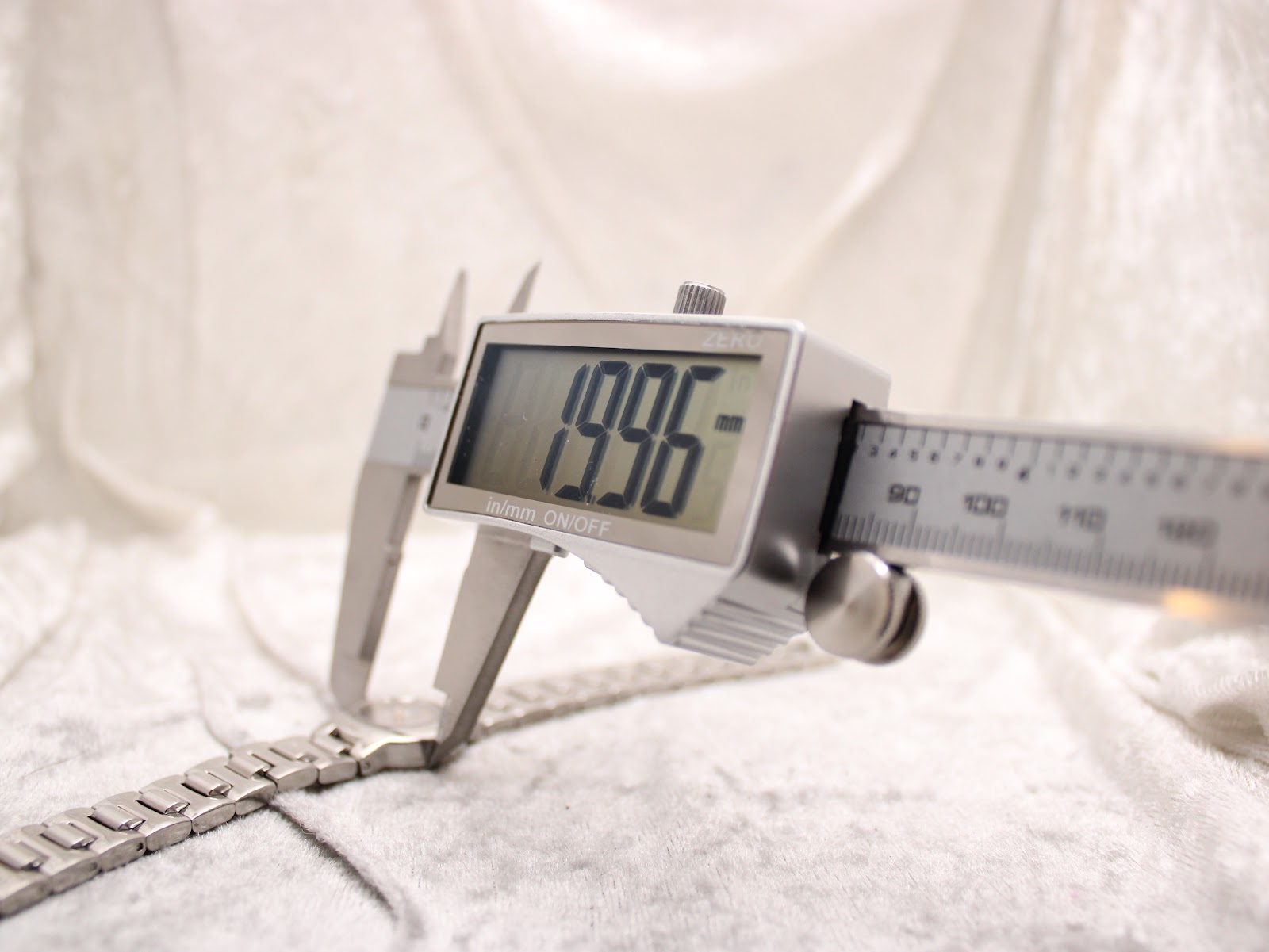 Digital caliper measuring the watch case diameter at precisely 19.96mm.