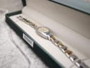 The Tissot G350 watch displayed inside an empty Tissot watch box, angled to show the dial and bracelet.