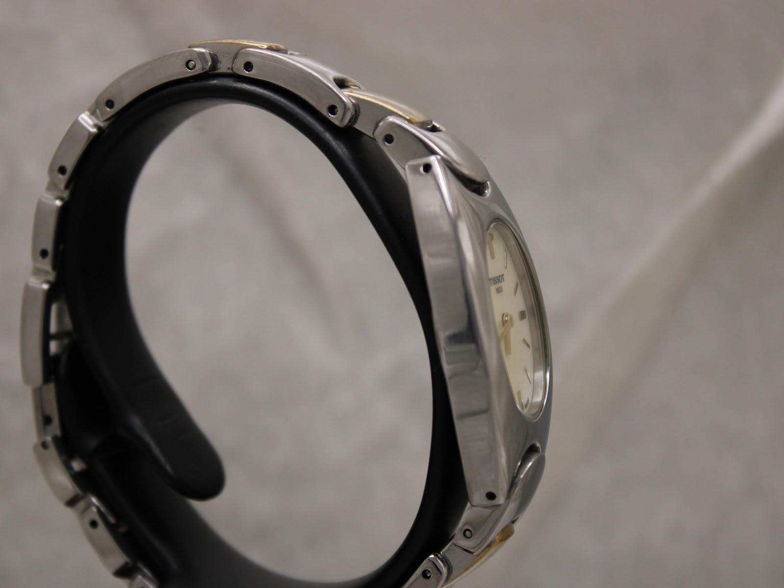 Another side view of the Tissot G350 watch, highlighting the two-tone links of the bracelet.