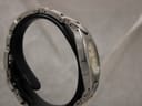 Another side view of the Tissot G350 watch, highlighting the two-tone links of the bracelet.
