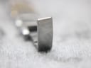 Close-up of the clasp on the Tissot G350 bracelet, showing the embossed 'T' logo.