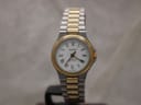Front view of a Tissot Seastar D317 ladies watch, showcasing its white Roman numeral dial and two-tone stainless steel and gold-tone bracelet.