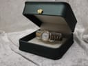 The Tissot Seastar D317 watch presented inside an open dark green box with a gold crown emblem on the lid.