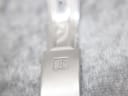 Detailed close-up of the Tissot signed fold-over clasp on the two-tone watch bracelet.