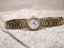 Straight-on front view of the Tissot Seastar D317 with its two-tone bracelet laid flat on a textured white surface.