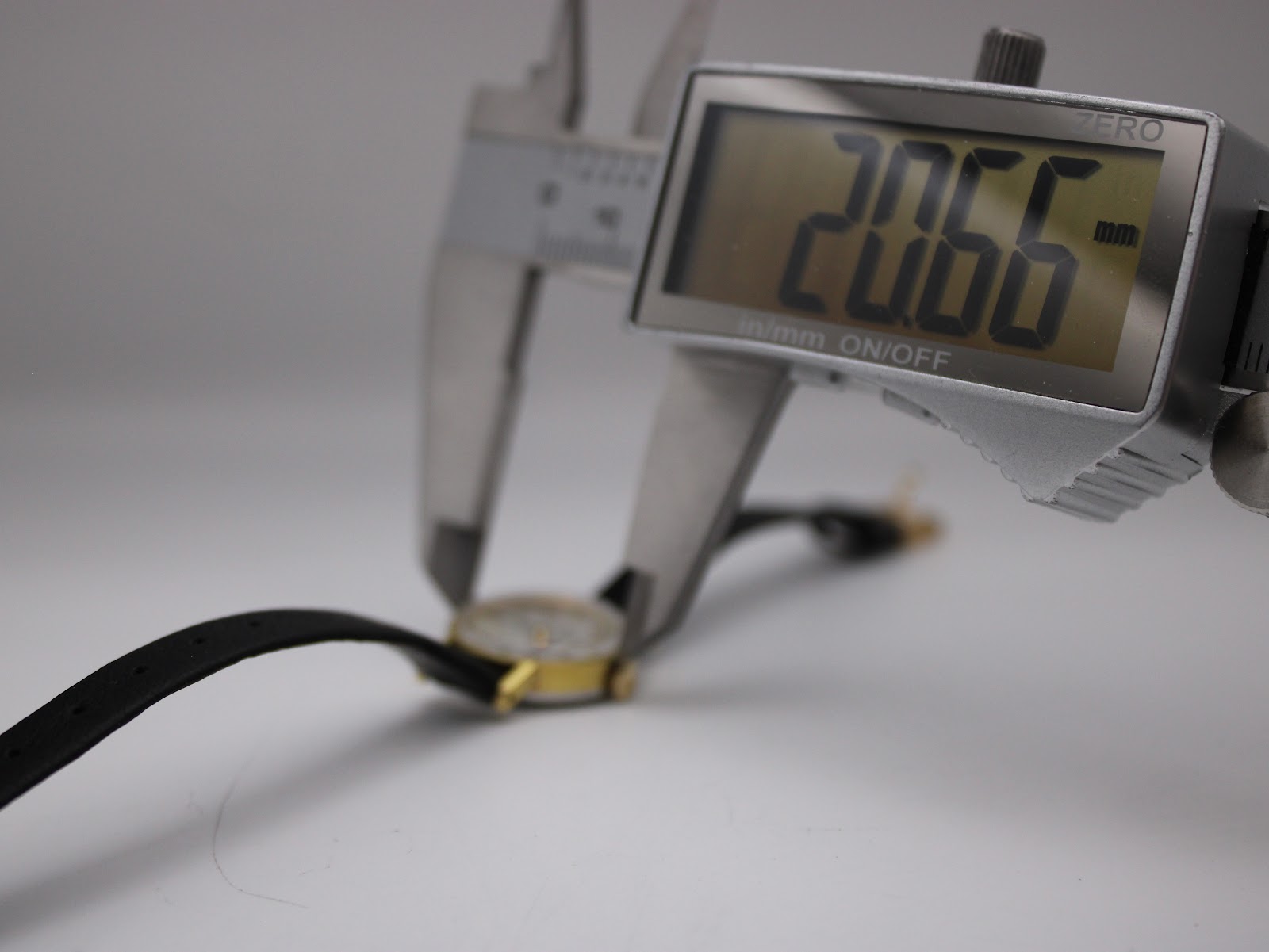 Digital caliper measuring the case diameter of the Tissot Stylist watch, displaying 20.66mm.