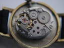 Close-up view of the Tissot calibre 2403 manual wind movement inside the watch, showing gears and jewels.
