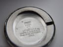 Close-up of the inside of the stainless steel case back, showing 'Chs Tissot & Fils Swiss Made' and 'Fond Acier Inoxydable 10602' engravings.