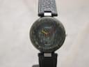 Front view of the Tissot RockWatch with green marble dial and case, showing yellow and red hands.