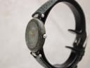 Side-profile view of the Tissot RockWatch, showing the minimalist green stone case and crown.