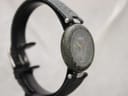 Angled front view of the Tissot RockWatch on a display stand, highlighting the unique green marble texture.