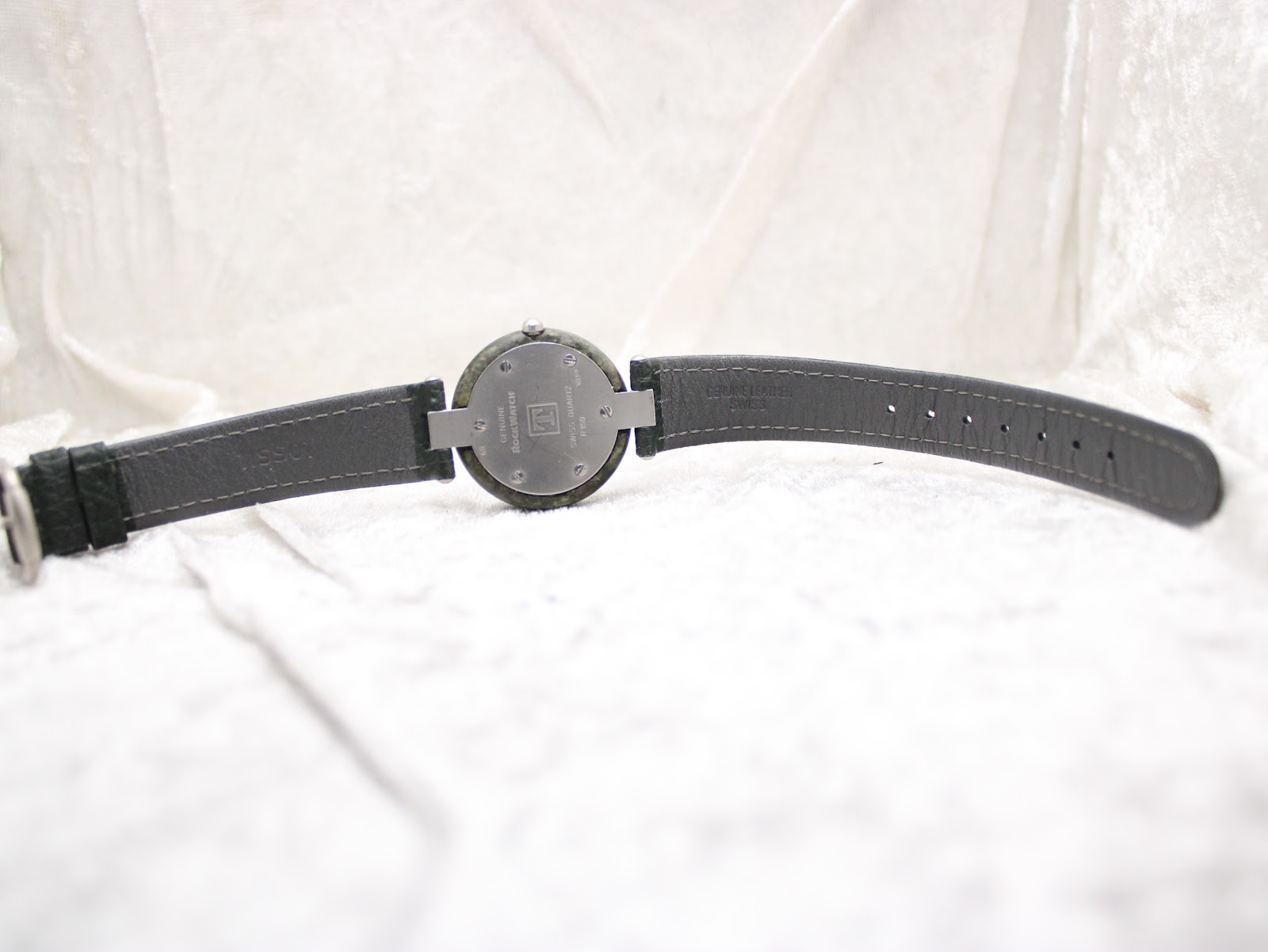 Full back view of the Tissot RockWatch and its green leather strap, showing the underside of the strap.