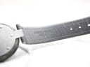 Close-up of the underside of the green leather strap, showing 'GENUINE LEATHER SWISS'.